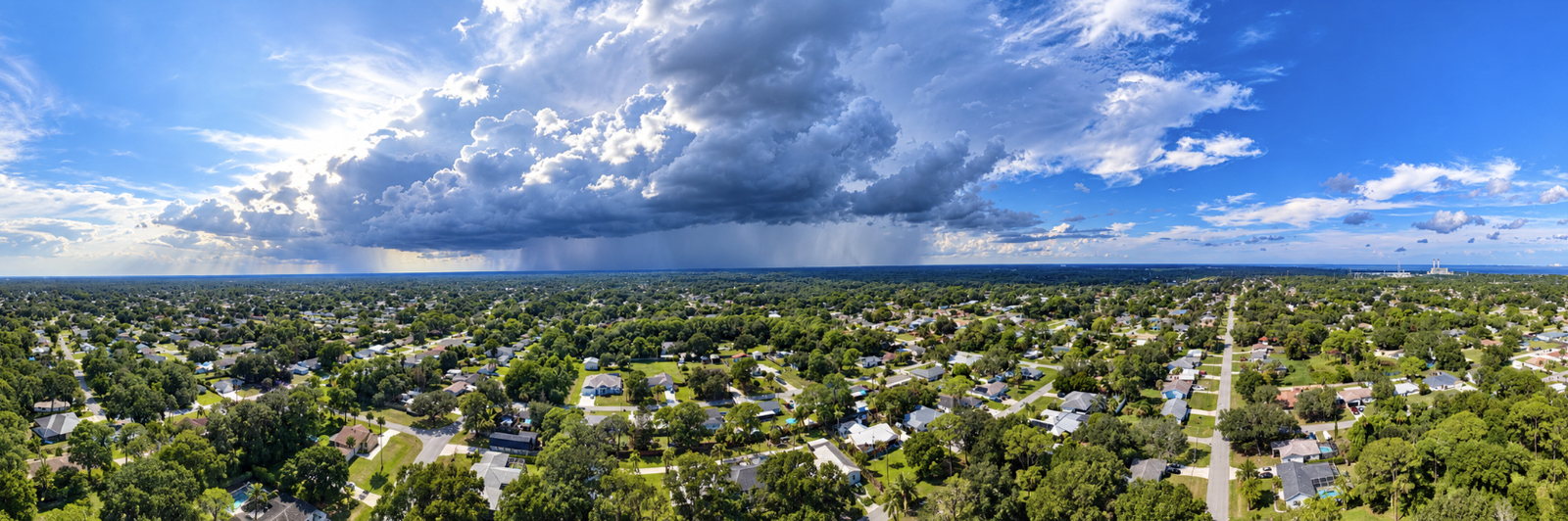 Wide aerial panorama of Port St. John beneath a dramatic storm